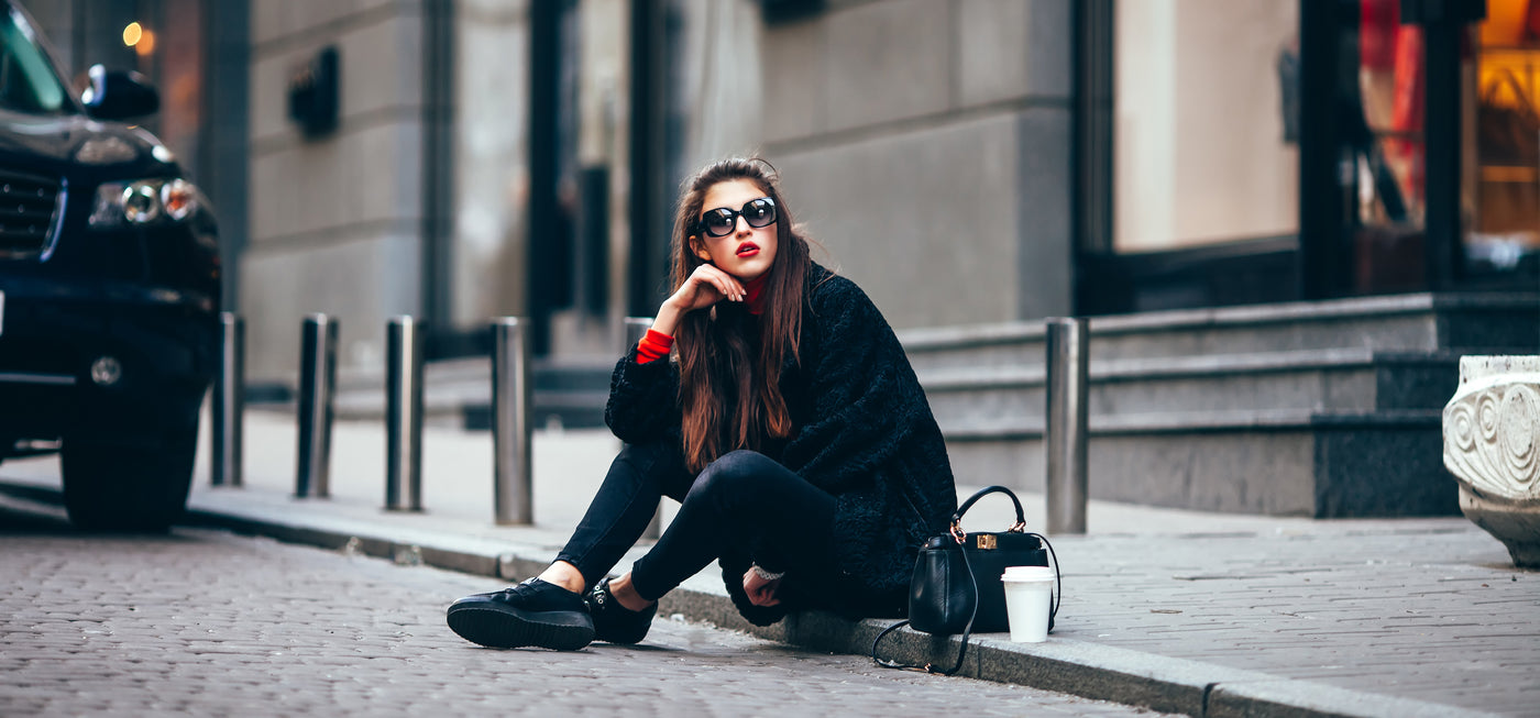 Woman sitting on curb downtown San Fran